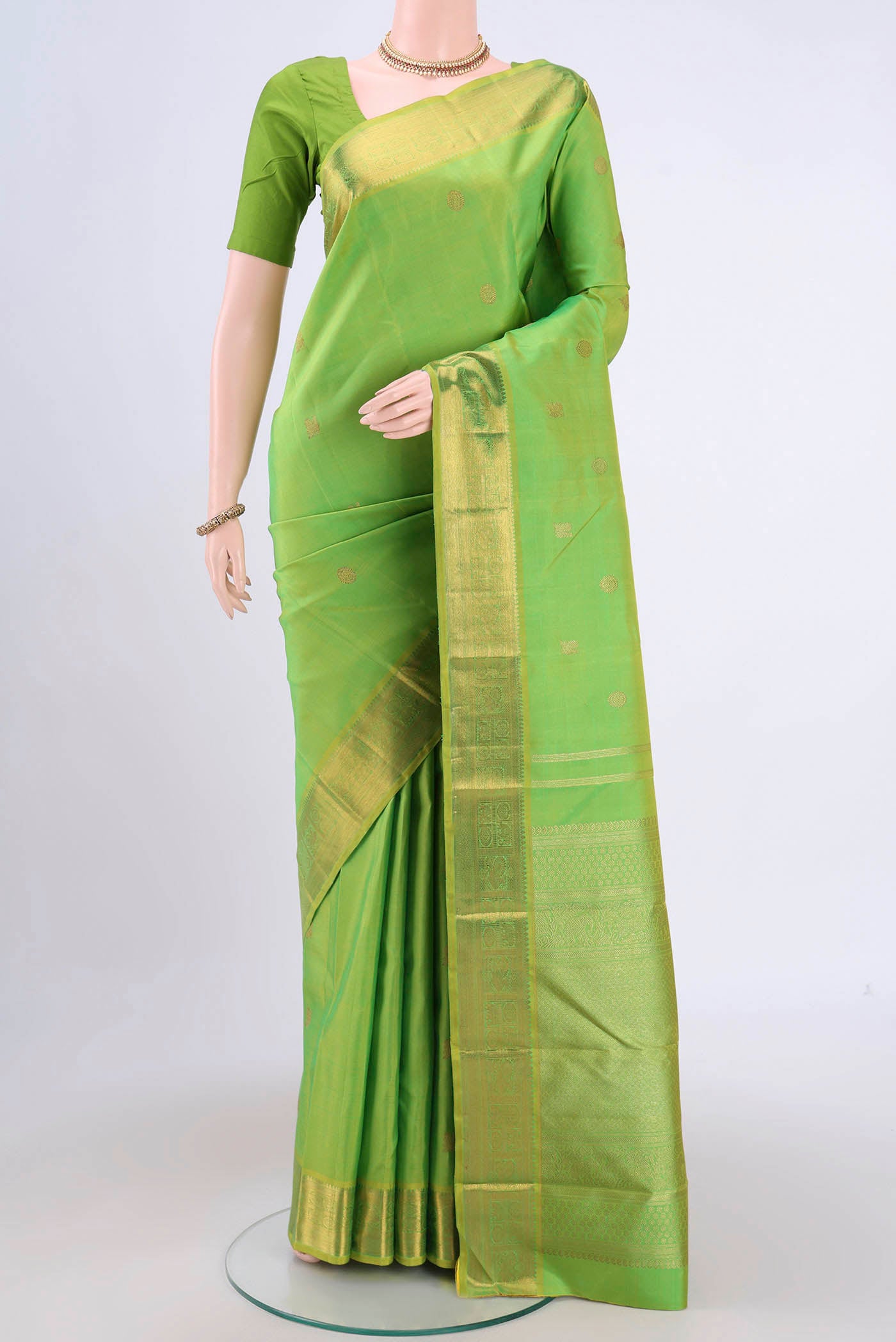 Pure Silk Pure Zari Parrot Green Dual Tone Kanchipuram Saree with Zari Butta on the body and Zari Border.  displayed on a mannequin