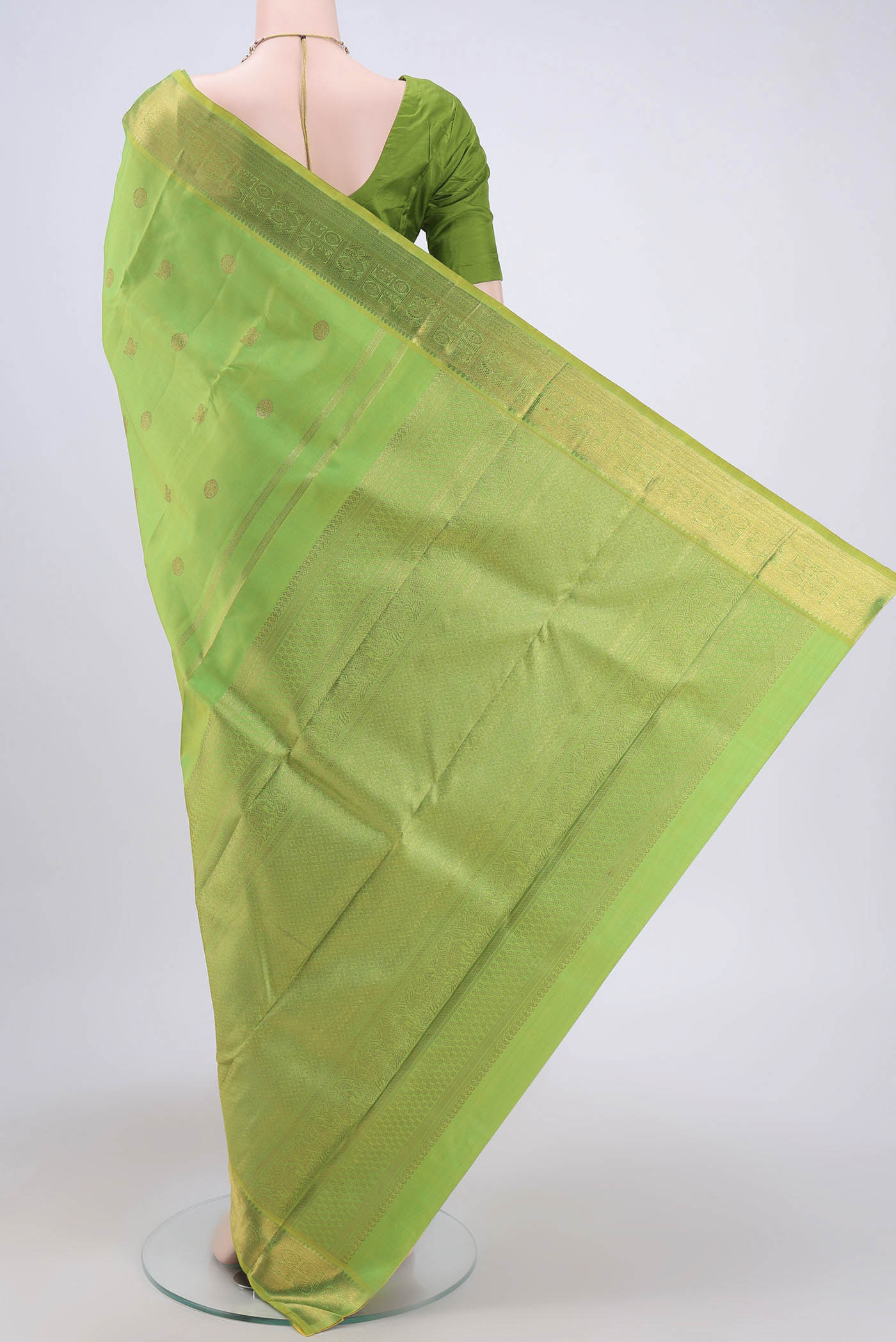 Flat view of Pure Silk Pure Zari Parrot Green Dual Tone Kanchipuram Saree with Zari Butta on the body and Zari Border. 