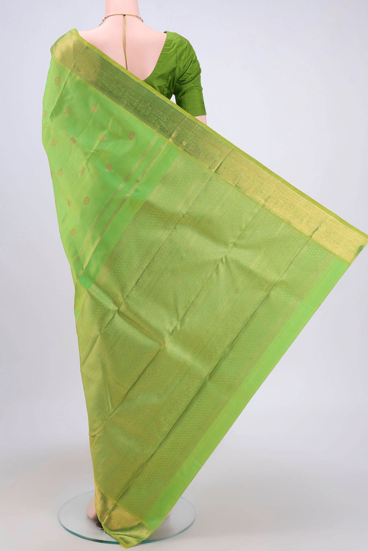 Flat view of Pure Silk Pure Zari Parrot Green Dual Tone Kanchipuram Saree with Zari Butta on the body and Zari Border. 