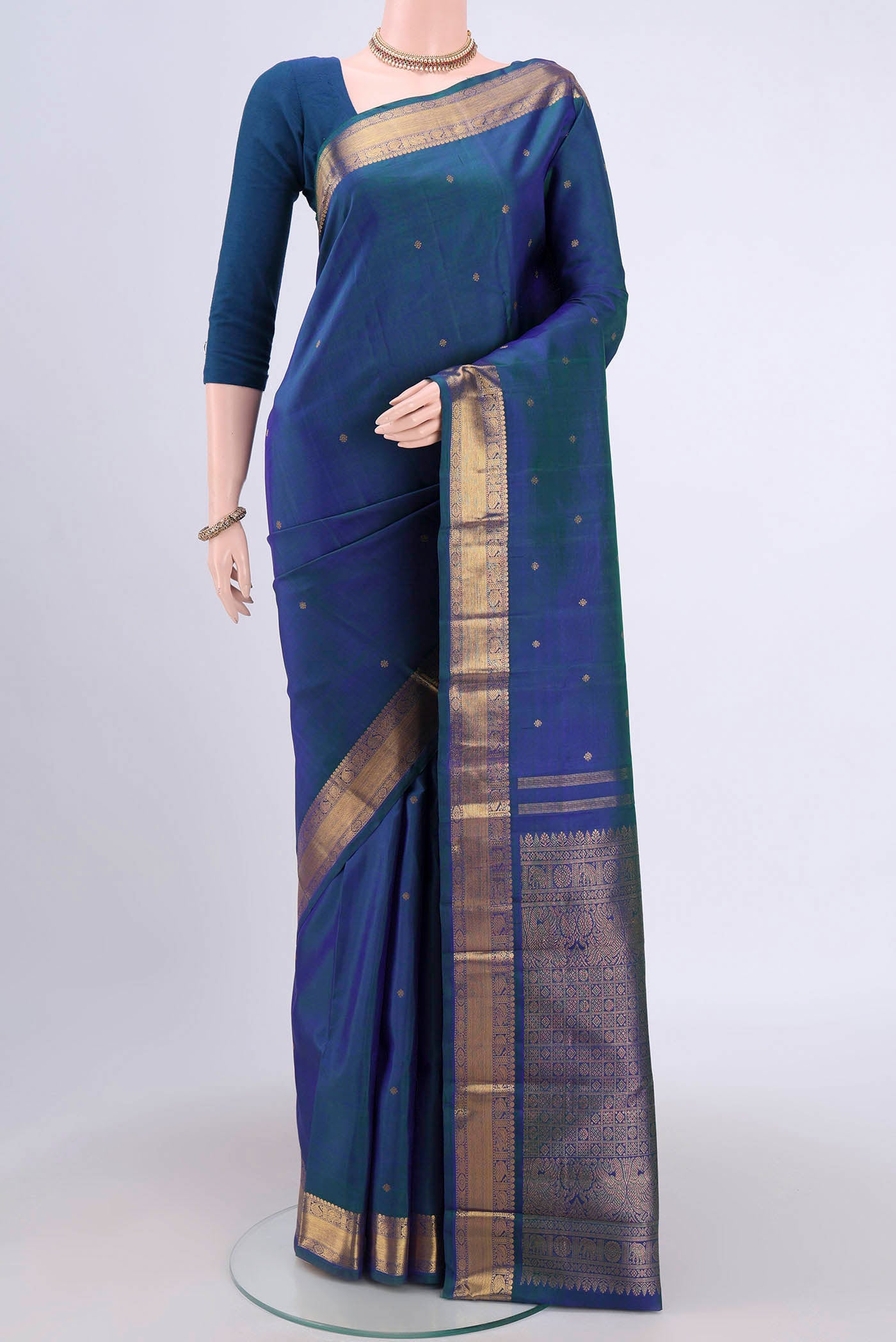 Pure Silk Pure Zari Peacock Blue Dual Tone Kanchipuram Saree with Zari Butta on the body and Zari Border.  displayed on a mannequin