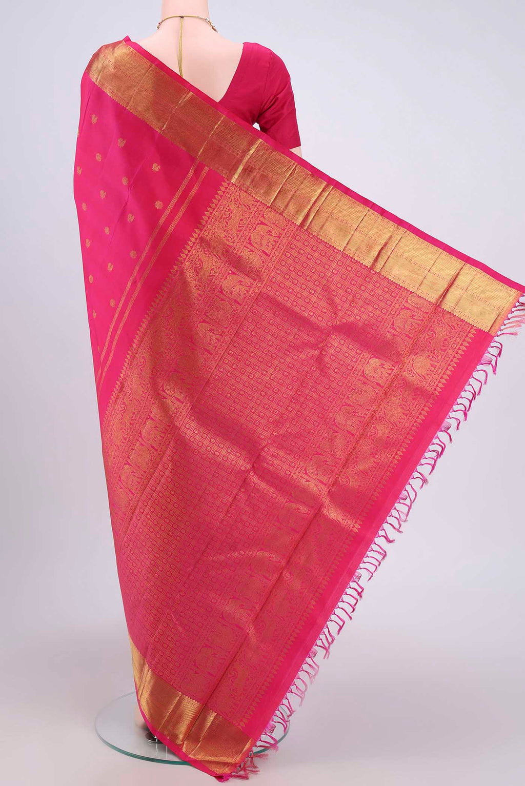 Flat view of Pure Silk Pure Zari Rani Pink Dual Tone Kanjivaram Saree with Zari Butta on the body and Zari Border. 