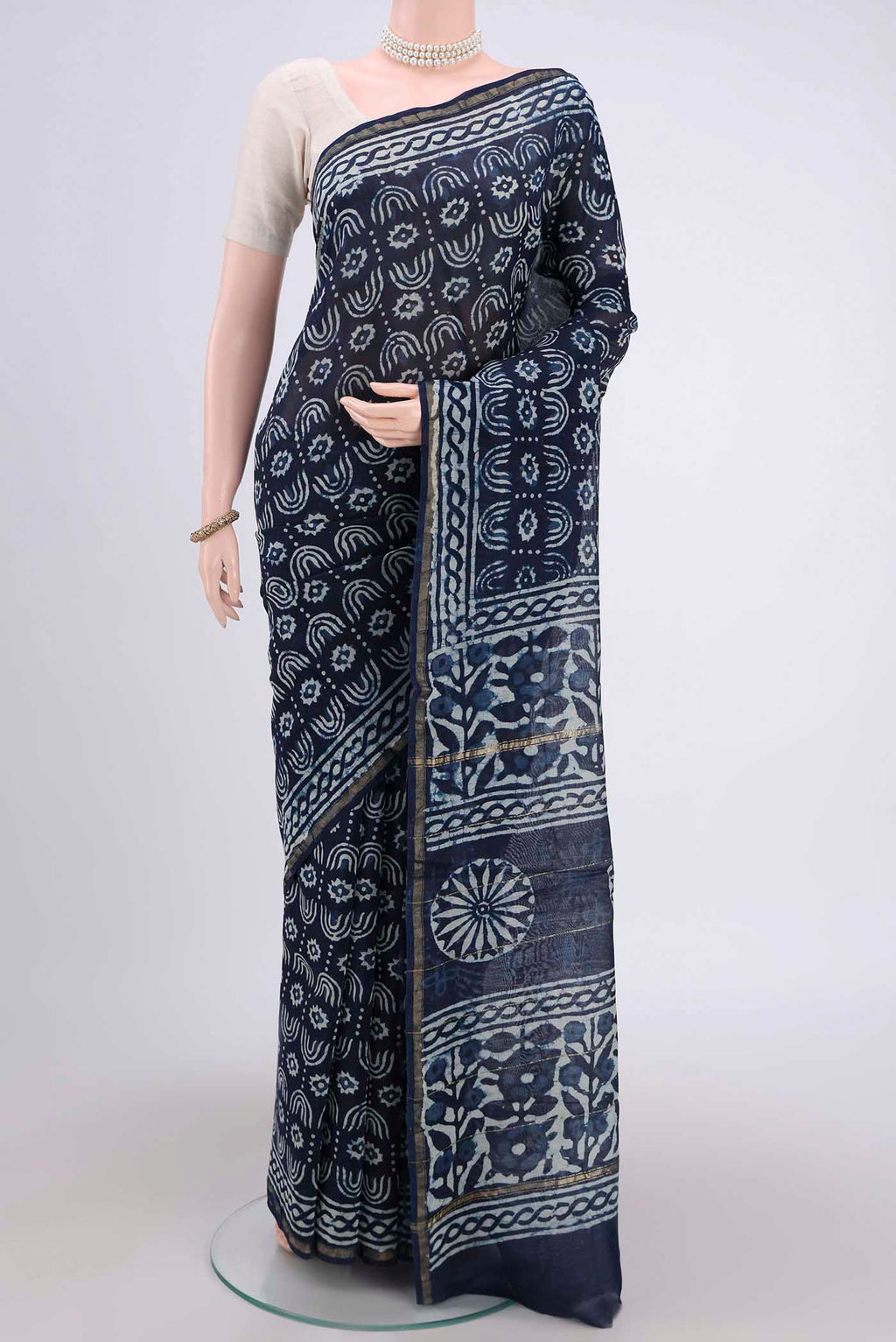 Indigo Maheshwari Silk Cotton Saree with Batik Print on the body and Zari Border.  displayed on a mannequin