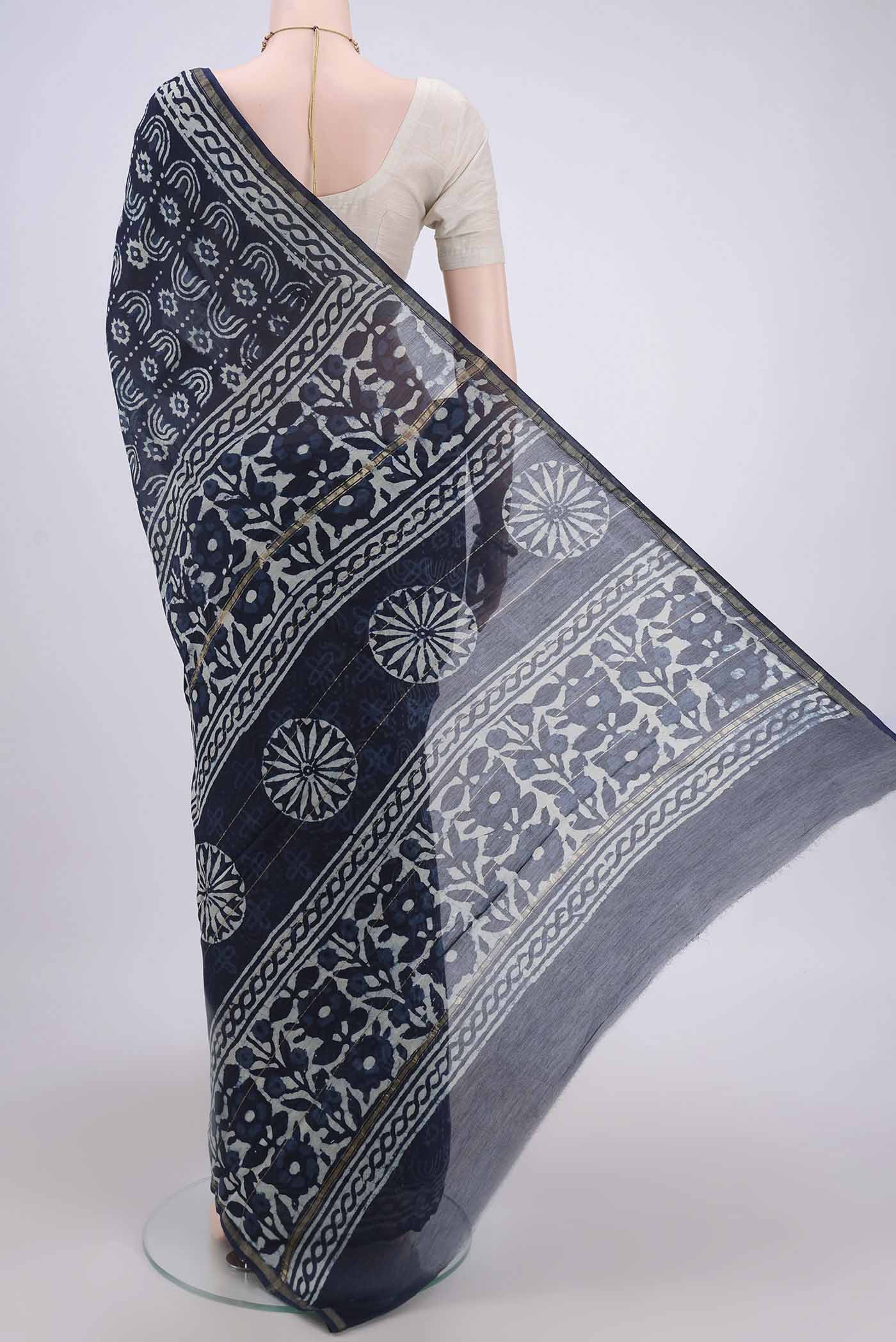 Flat view of Indigo Maheshwari Silk Cotton Saree with Batik Print on the body and Zari Border. 