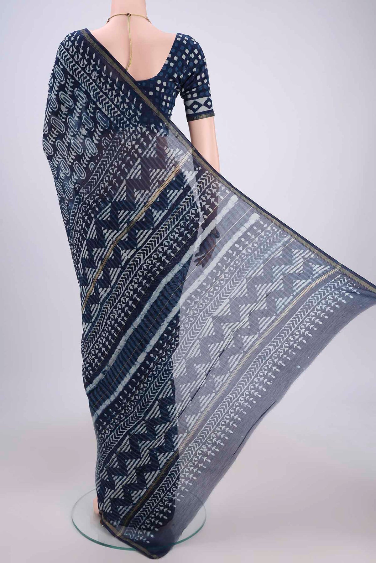 Flat view of Indigo Chanderi Silk Saree with Batik Print on the body and Zari Border. 