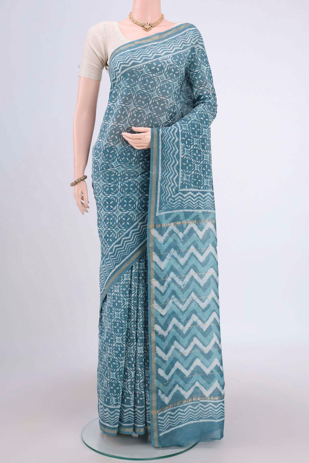 Maya Blue Maheshwari Silk Cotton Saree with Printed design on the body and Thin Zari Line.  displayed on a mannequin