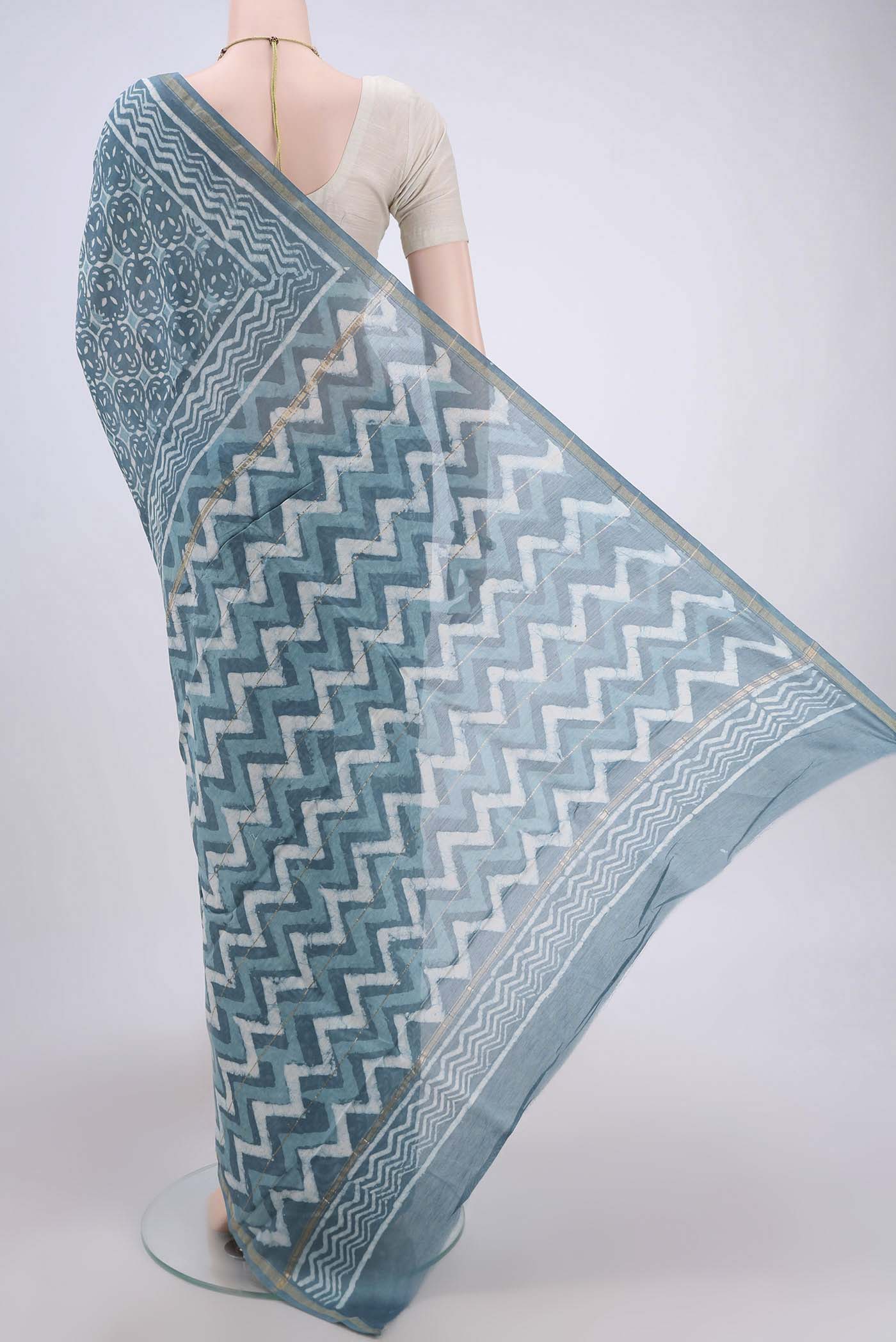 Flat view of Maya Blue Maheshwari Silk Cotton Saree with Printed design on the body and Thin Zari Line. 