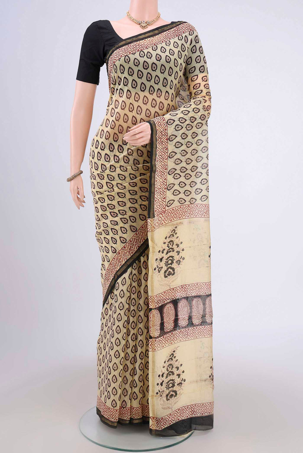 Cream Chanderi Silk Cotton Saree with Printed design on the body and Zari Border.  displayed on a mannequin