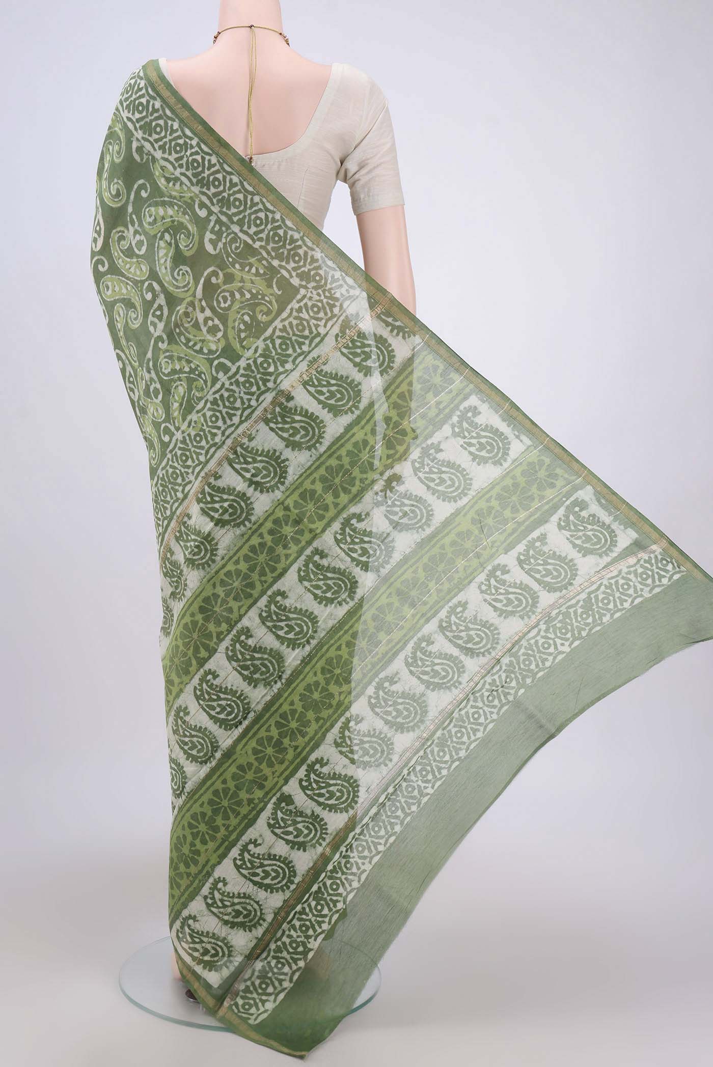 Flat view of Light Green Maheshwari Silk Cotton Saree with Batik Print on the body and Zari Border. 