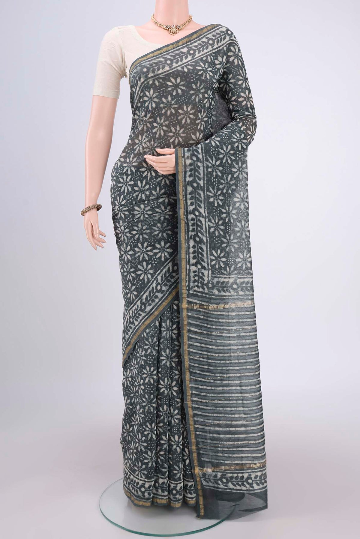 Davys Grey Chanderi Silk Saree with Batik Print on the body and Zari Border.  displayed on a mannequin