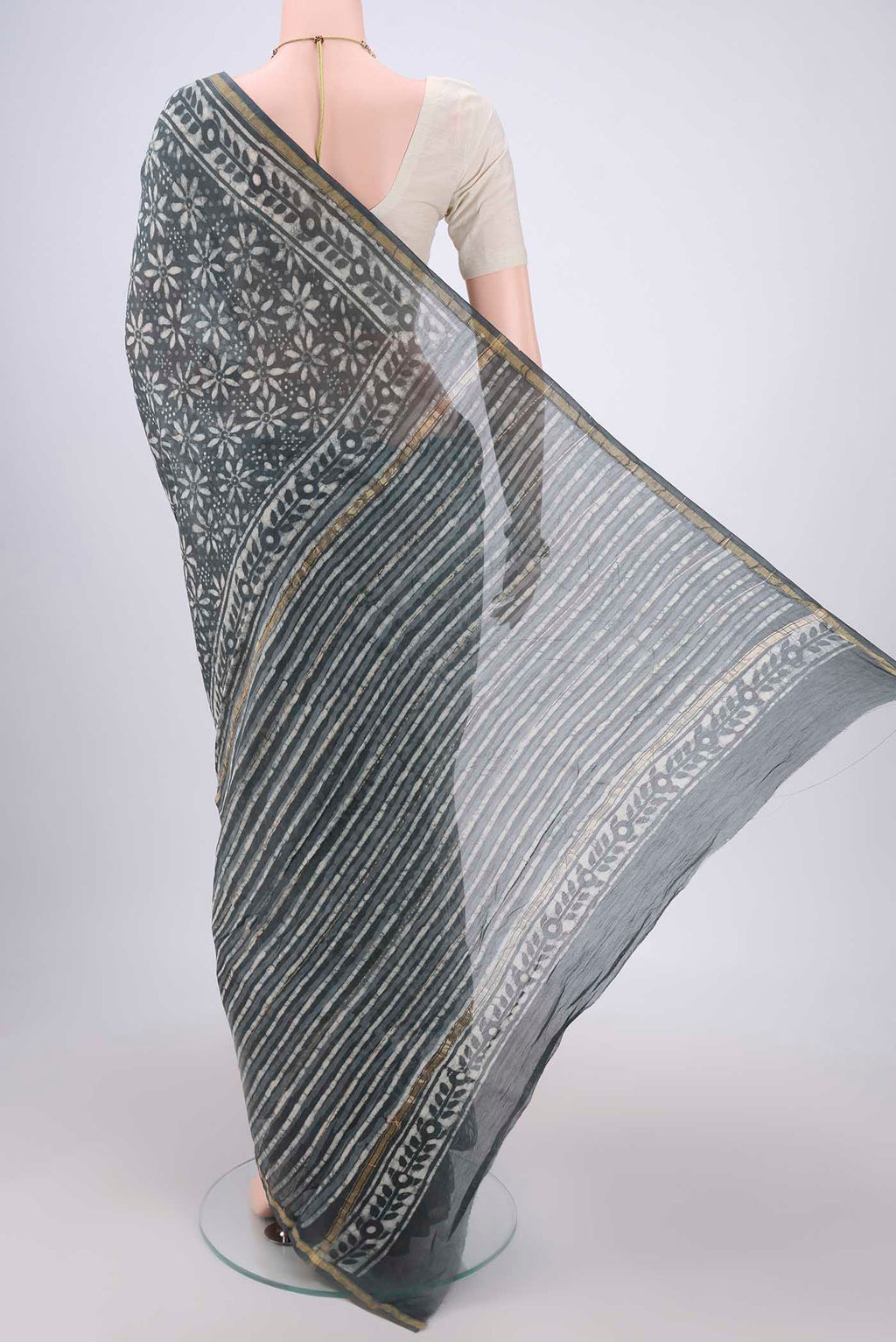 Flat view of Davys Grey Chanderi Silk Saree with Batik Print on the body and Zari Border. 