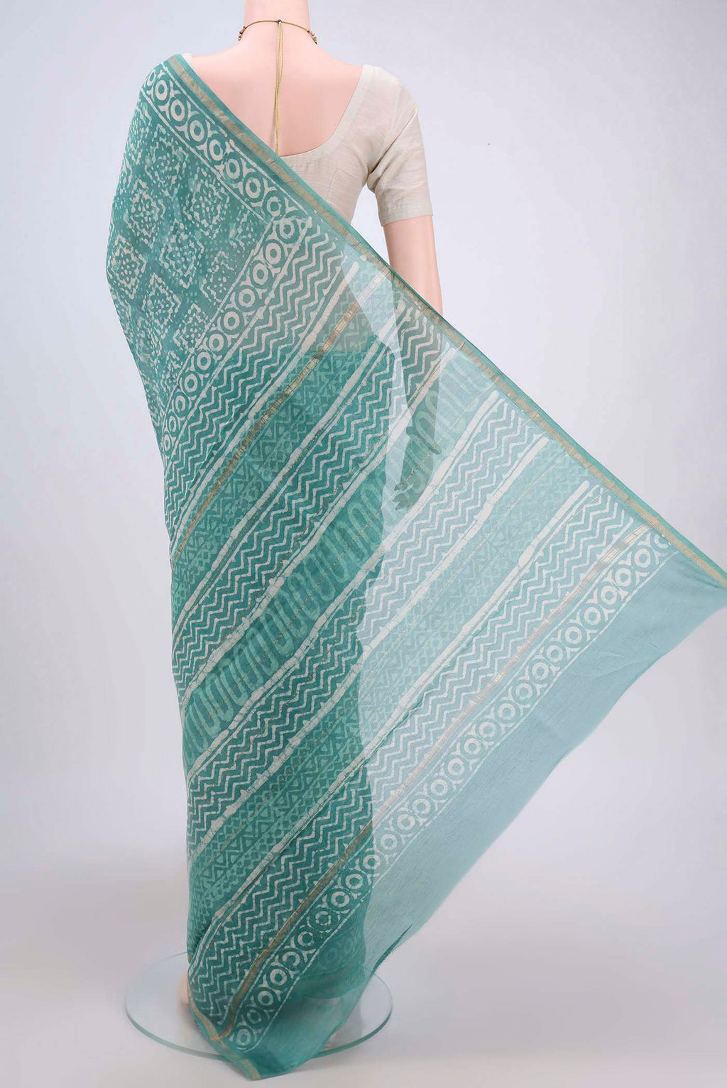 Flat view of Turquoise Maheshwari Silk Cotton Saree with Batik Print on the body and Zari Border. 