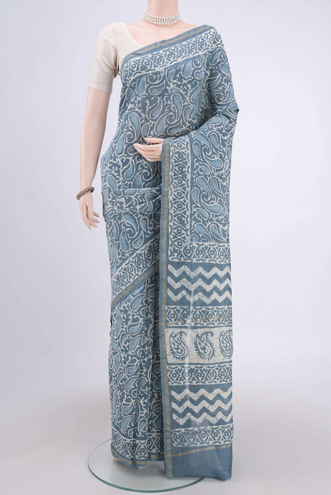 Blue Maheshwari Silk Cotton Saree with Batik Print on the body and Zari Border.  displayed on a mannequin