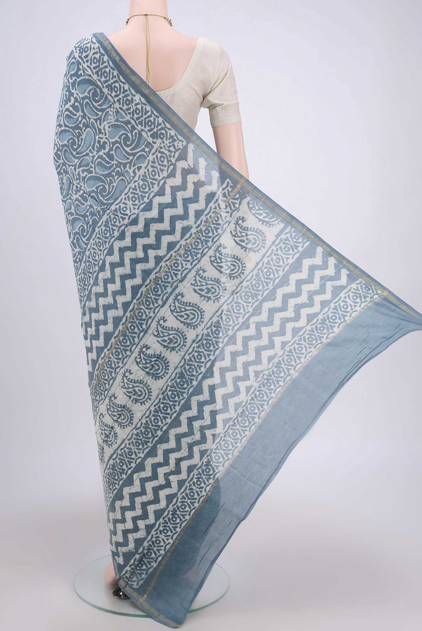 Flat view of Blue Maheshwari Silk Cotton Saree with Batik Print on the body and Zari Border. 