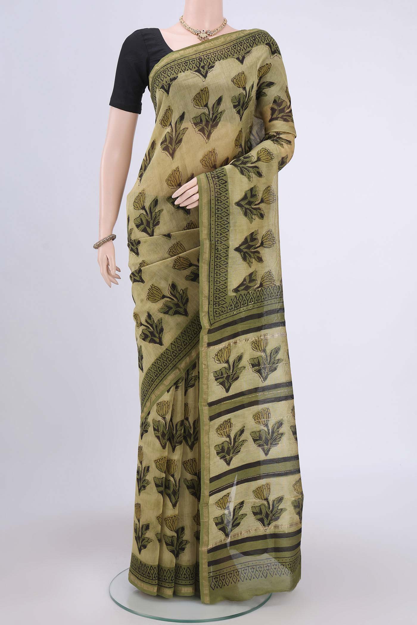 Light Green Chanderi Silk Saree with Printed design on the body and Zari Border.  displayed on a mannequin