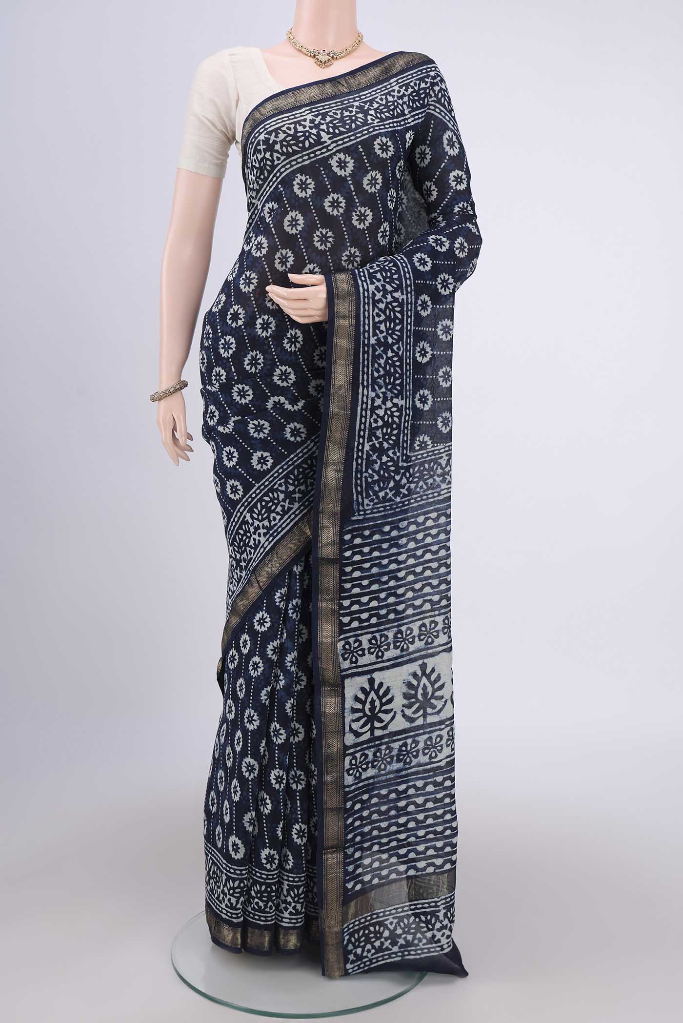 Indigo Maheshwari Silk Cotton Saree with Batik Print on the body and Zari Border.  displayed on a mannequin
