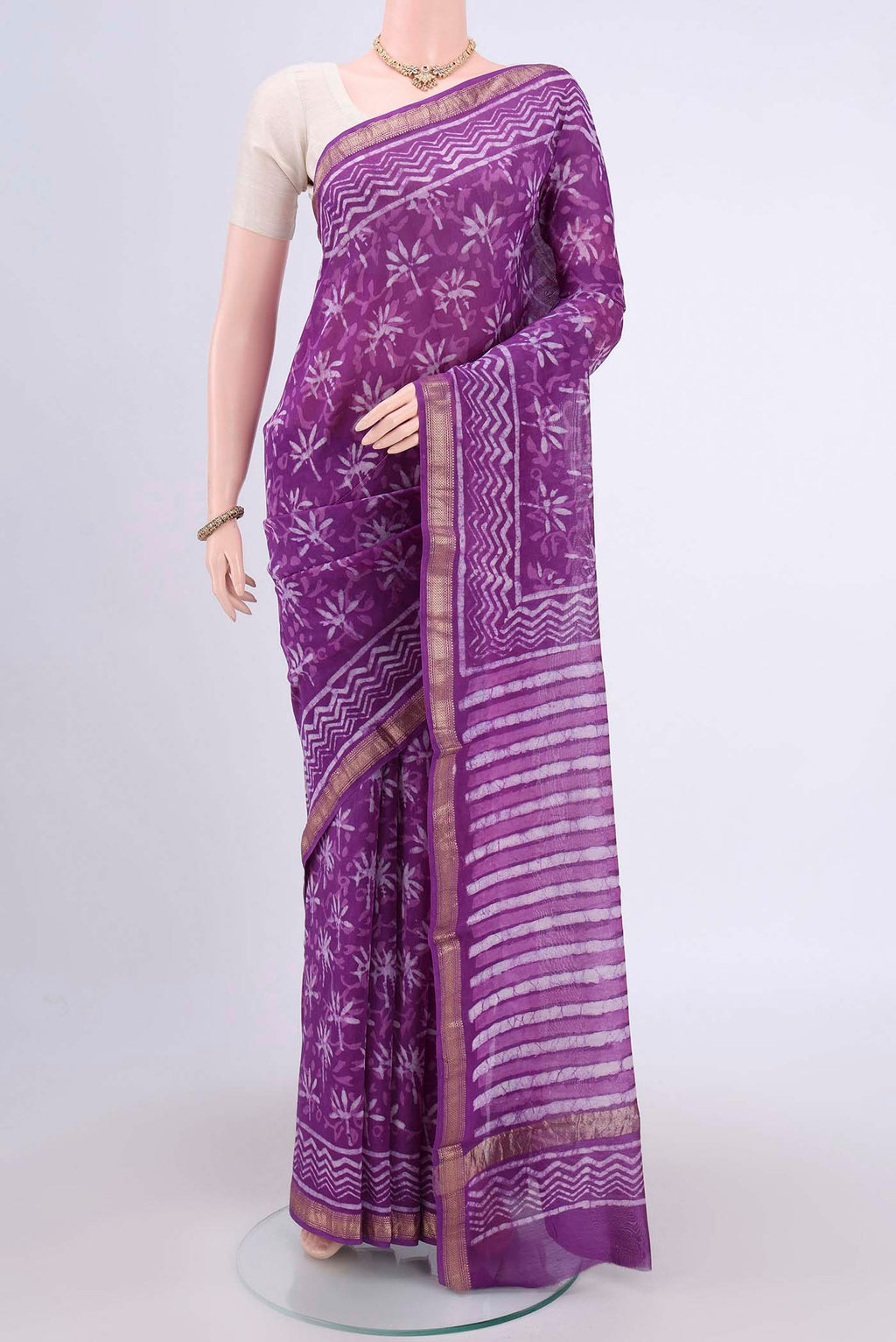 Purple Maheshwari Silk Cotton Saree with Printed design on the body and Zari Border.  displayed on a mannequin