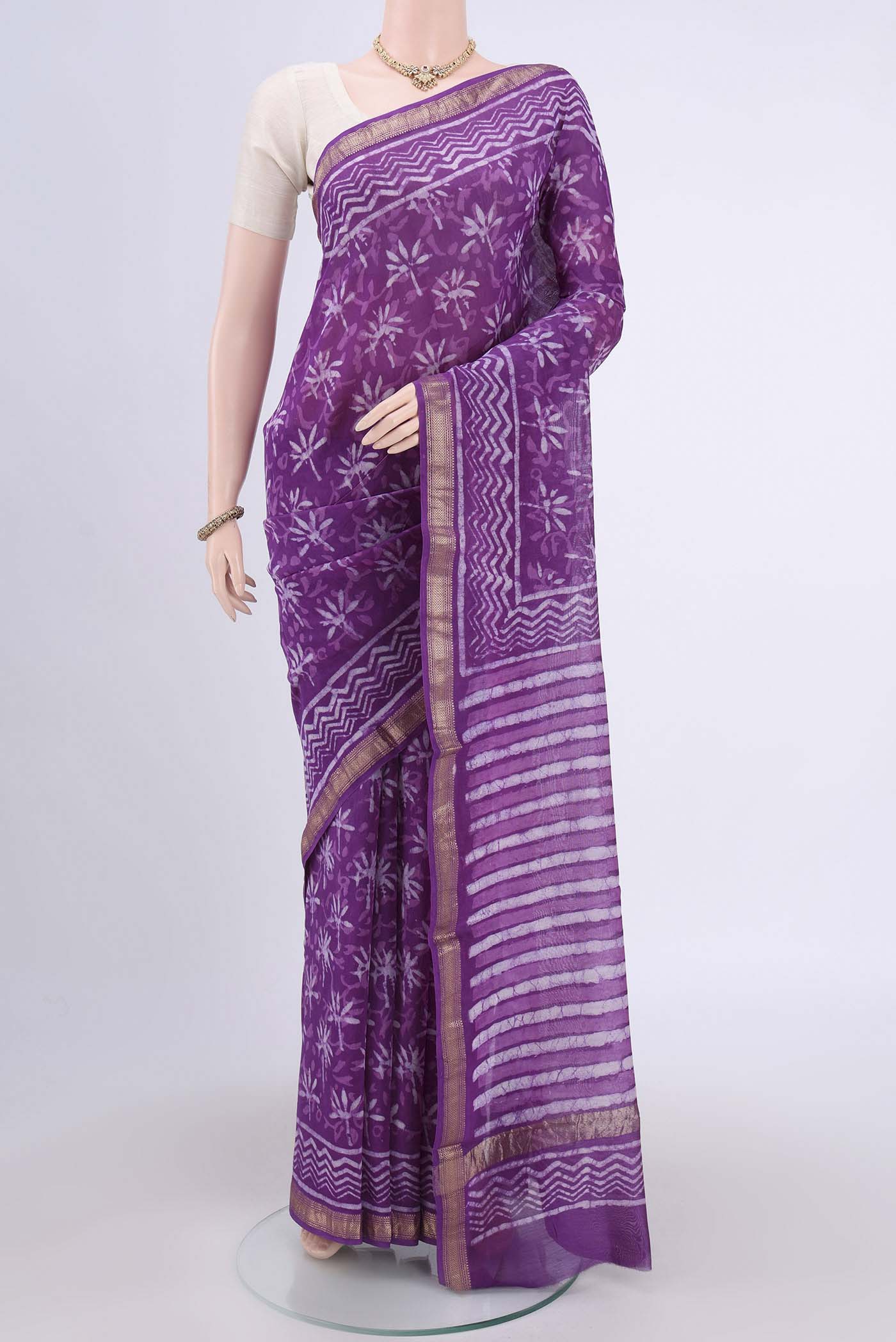 Purple Maheshwari Silk Cotton Saree with Printed design on the body and Zari Border.  displayed on a mannequin