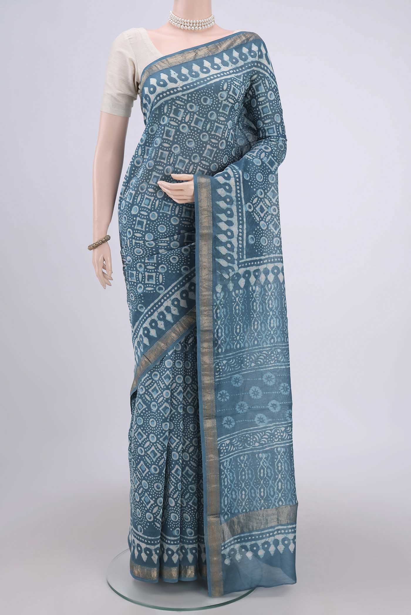 Blue Maheshwari Silk Cotton Saree with Batik Print on the body and Zari Border.  displayed on a mannequin