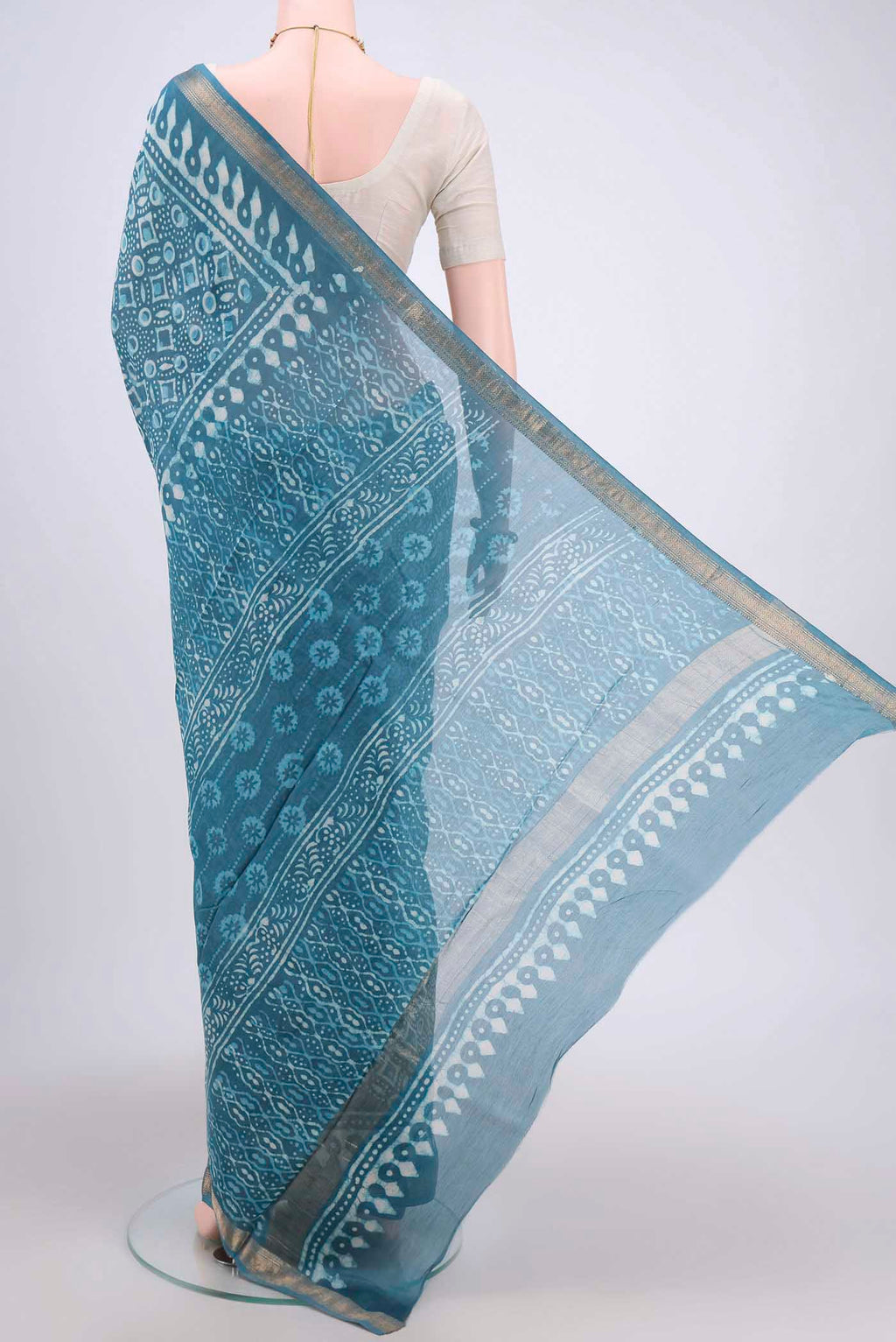 Flat view of Blue Maheshwari Silk Cotton Saree with Batik Print on the body and Zari Border. 