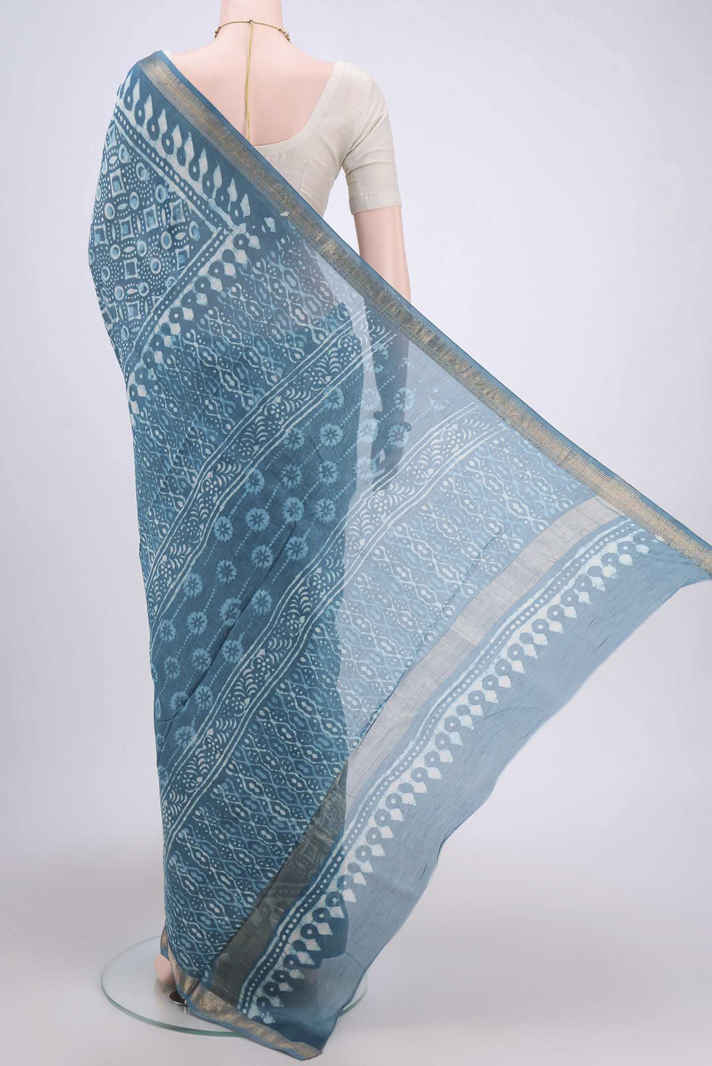 Flat view of Blue Maheshwari Silk Cotton Saree with Batik Print on the body and Zari Border. 