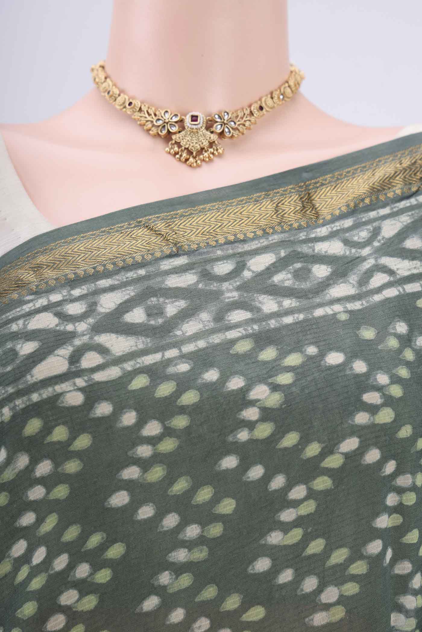 Border image of Olive Green Maheshwari Silk Cotton Saree with Batik Print on the body and Zari Border. 