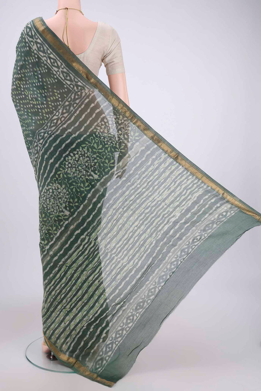 Flat view of Olive Green Maheshwari Silk Cotton Saree with Batik Print on the body and Zari Border. 