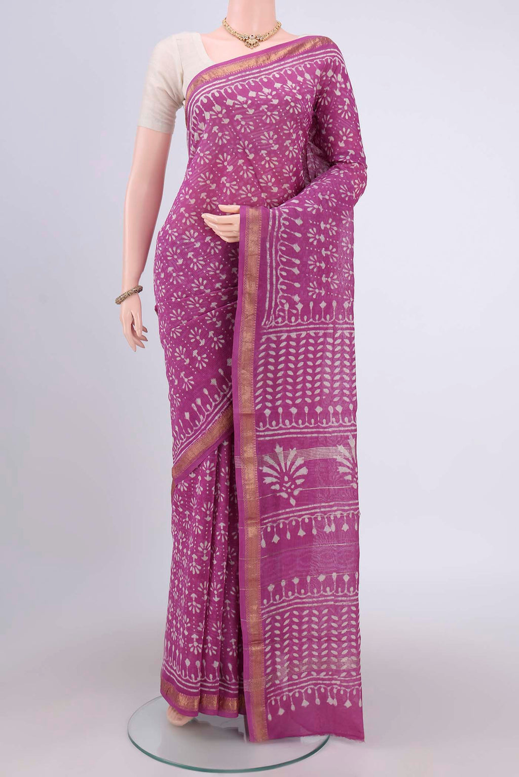 Pink Maheshwari Silk Cotton Saree with Batik Print on the body and Zari Border.  displayed on a mannequin