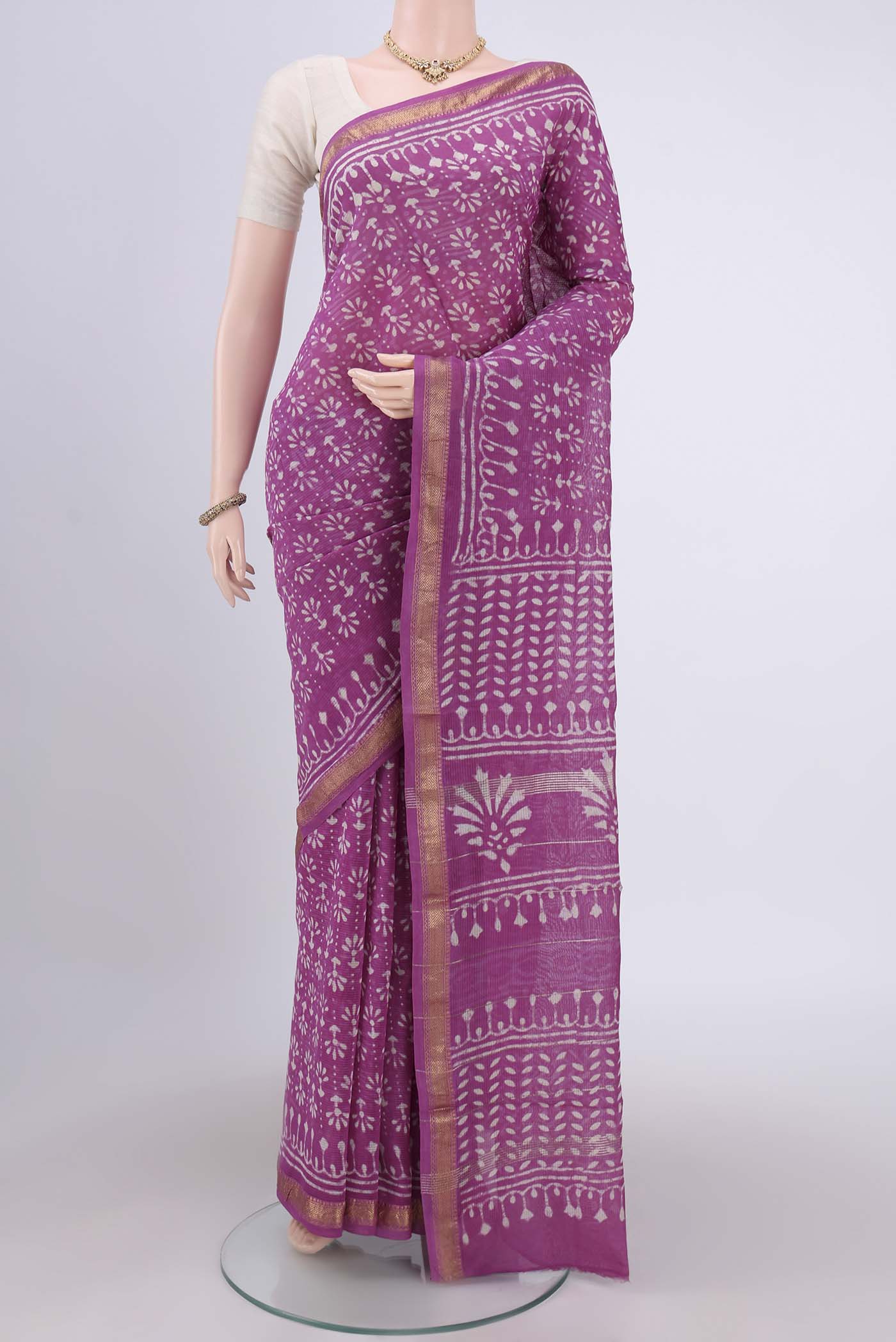 Pink Maheshwari Silk Cotton Saree with Batik Print on the body and Zari Border.  displayed on a mannequin