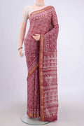 Pink Maheshwari Silk Cotton Saree with Batik Print on the body and Zari Border.  displayed on a mannequin