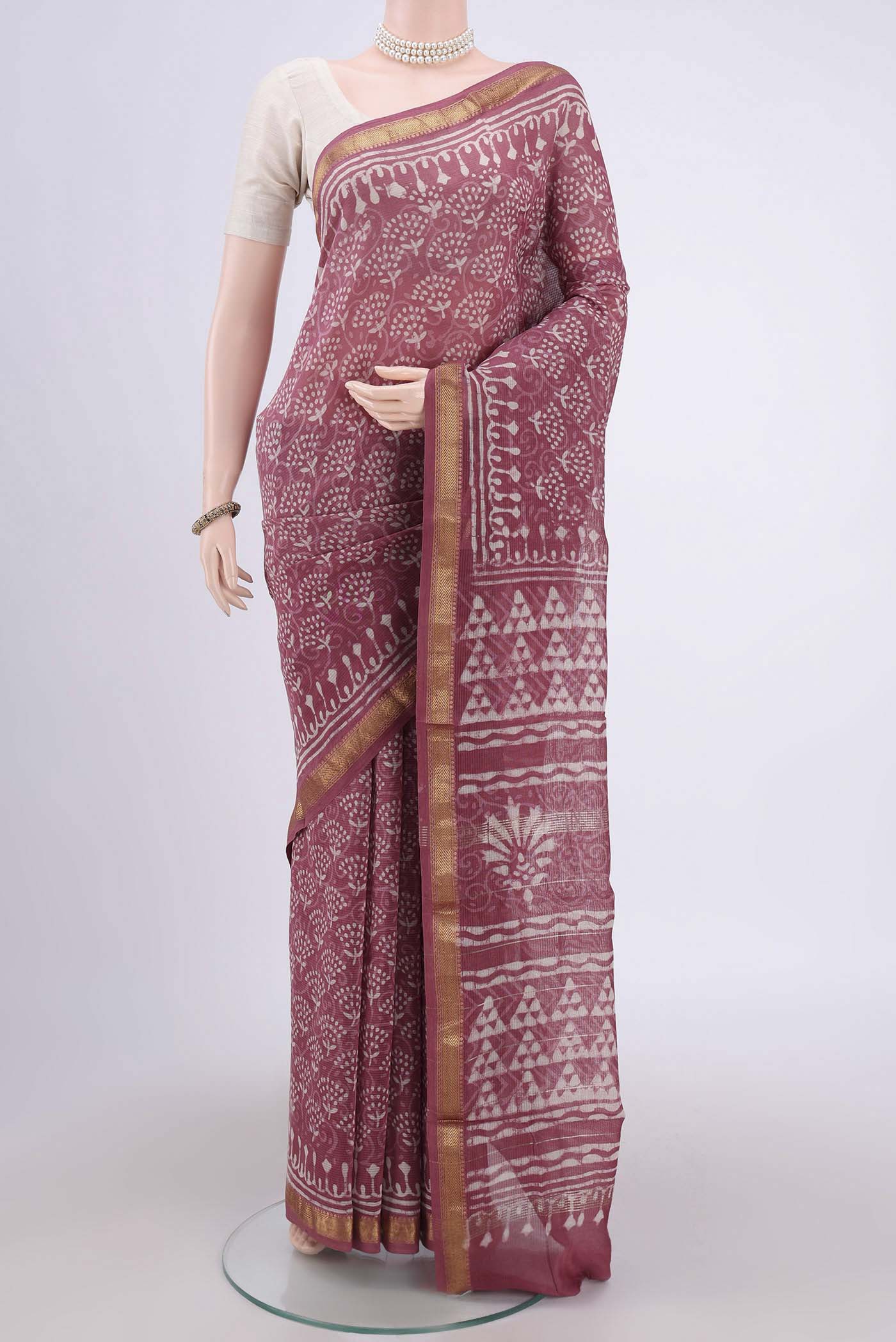 Pink Maheshwari Silk Cotton Saree with Batik Print on the body and Zari Border.  displayed on a mannequin