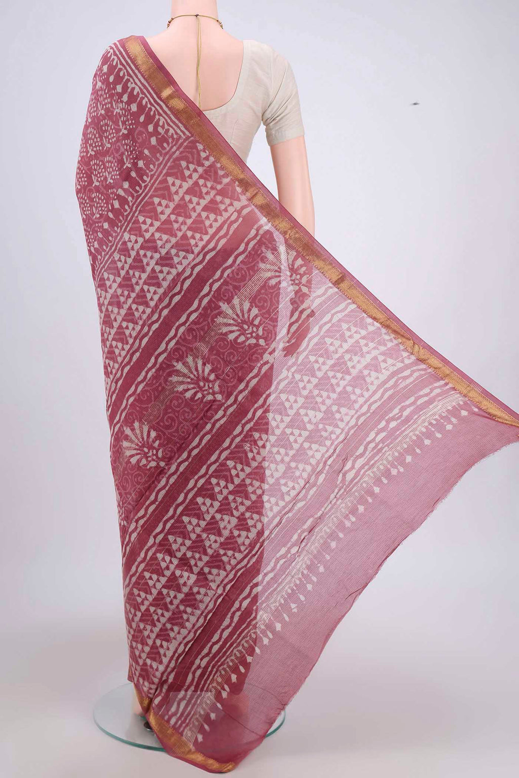 Flat view of Pink Maheshwari Silk Cotton Saree with Batik Print on the body and Zari Border. 