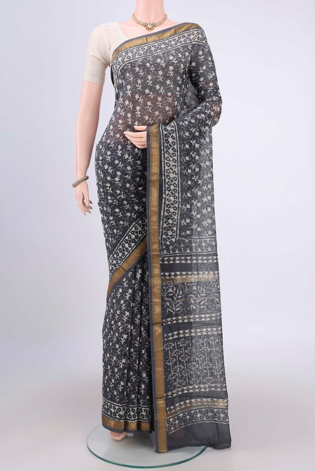 Davys Grey Maheshwari Silk Cotton Saree with Batik Print on the body and Zari Border.  displayed on a mannequin