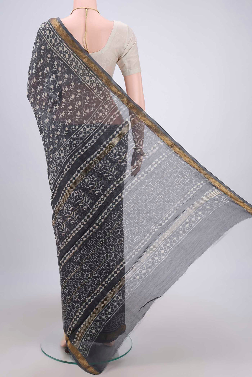 Flat view of Davys Grey Maheshwari Silk Cotton Saree with Batik Print on the body and Zari Border. 
