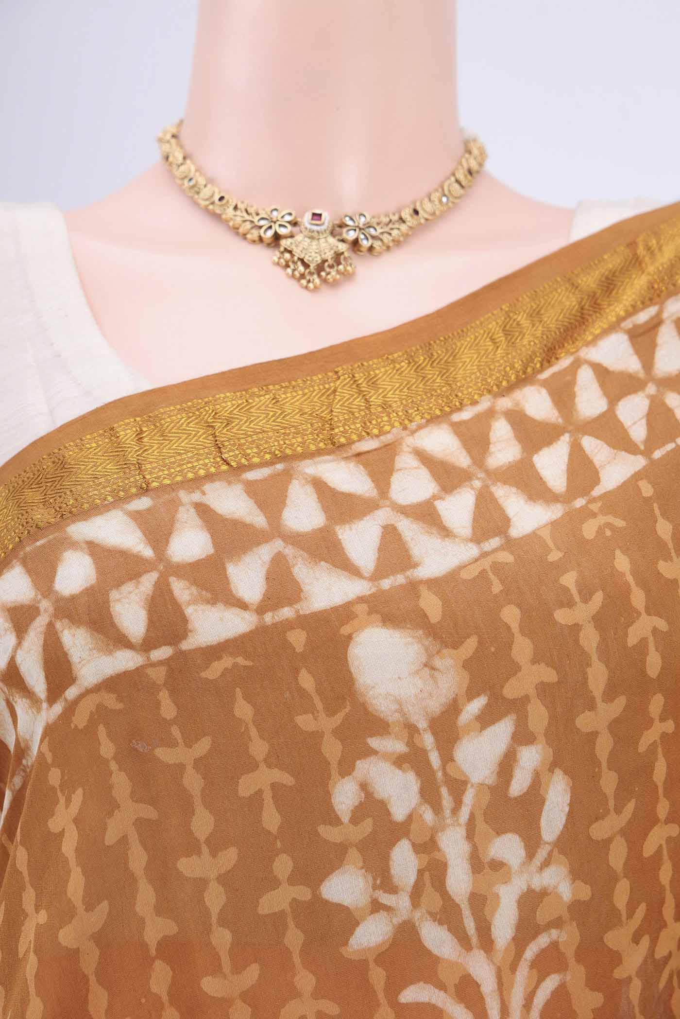Border image of Rust Maheshwari Silk Cotton Saree with Printed design on the body and Zari Border. 