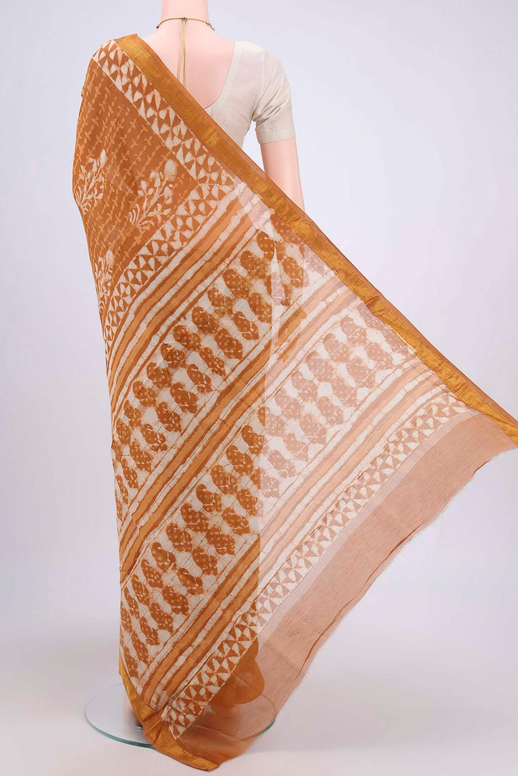 Flat view of Rust Maheshwari Silk Cotton Saree with Printed design on the body and Zari Border. 