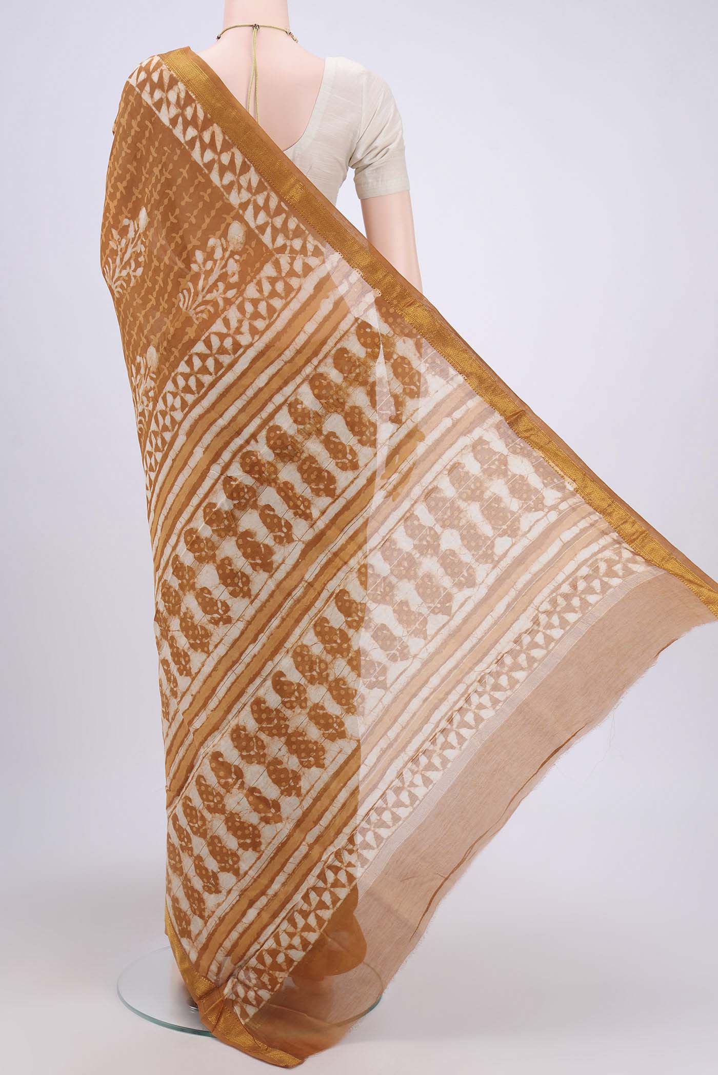 Flat view of Rust Maheshwari Silk Cotton Saree with Printed design on the body and Zari Border. 