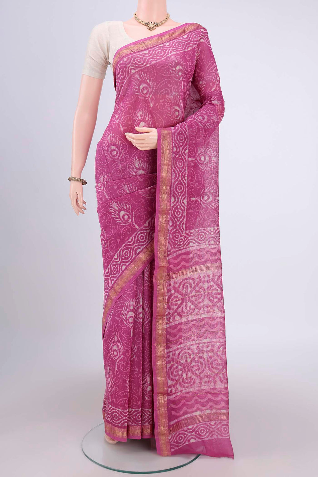 Pink Maheshwari Silk Cotton Saree with Batik Print on the body and Zari Border.  displayed on a mannequin