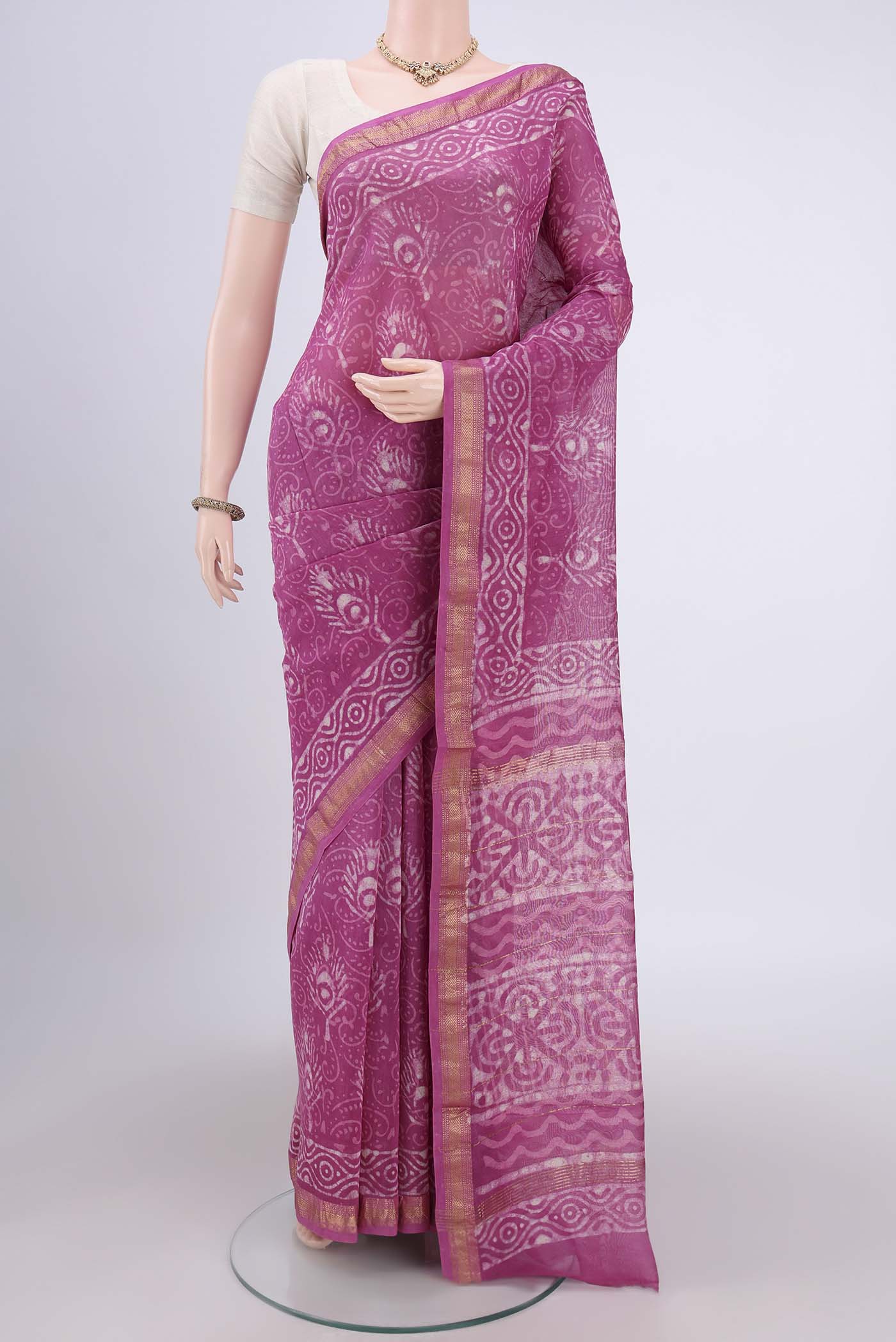Pink Maheshwari Silk Cotton Saree with Batik Print on the body and Zari Border.  displayed on a mannequin