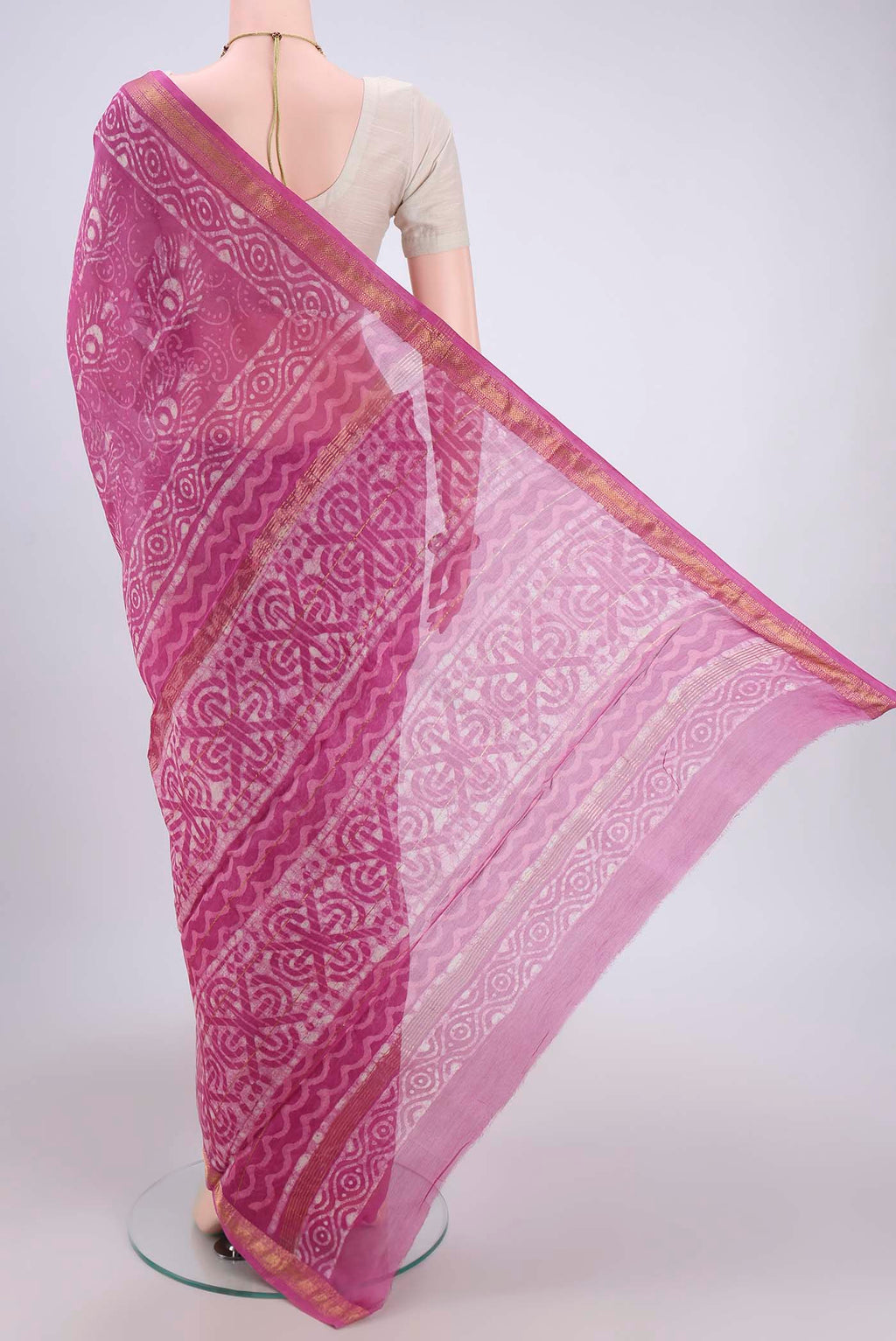 Flat view of Pink Maheshwari Silk Cotton Saree with Batik Print on the body and Zari Border. 