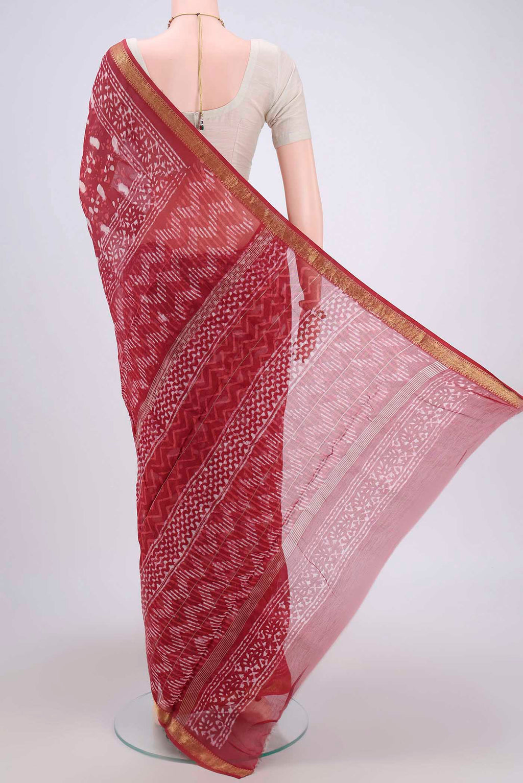 Flat view of Coral Maheshwari Silk Cotton Saree with Batik Print on the body and Zari Border. 