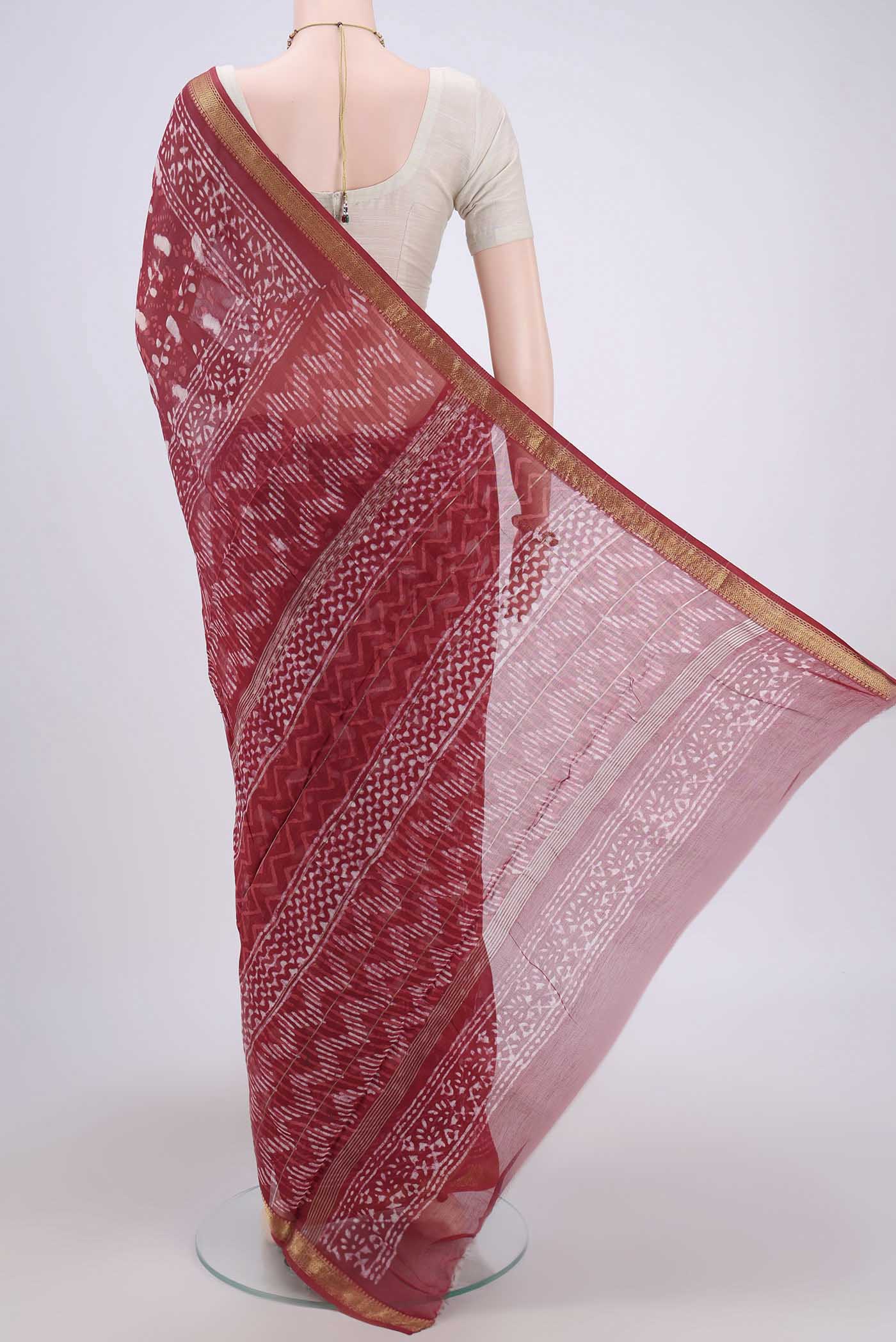 Flat view of Coral Maheshwari Silk Cotton Saree with Batik Print on the body and Zari Border. 