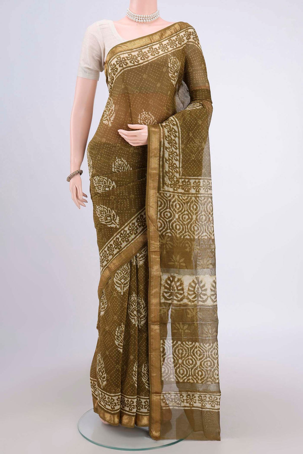 Mehandi Green Maheshwari Silk Cotton Saree with Batik Print on the body and Zari Border.  displayed on a mannequin