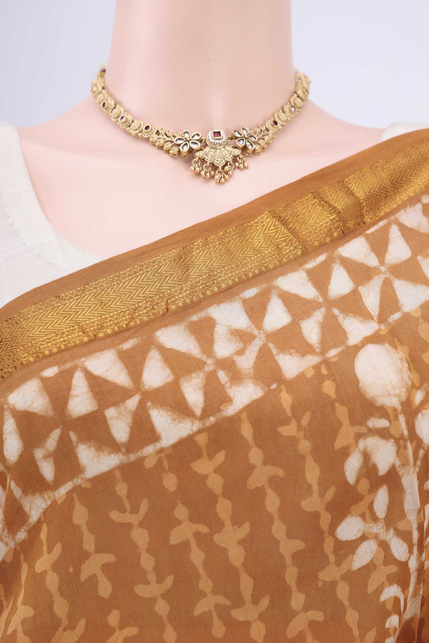 Border image of Rust Maheshwari Silk Cotton Saree with Printed design on the body and Zari Border. 