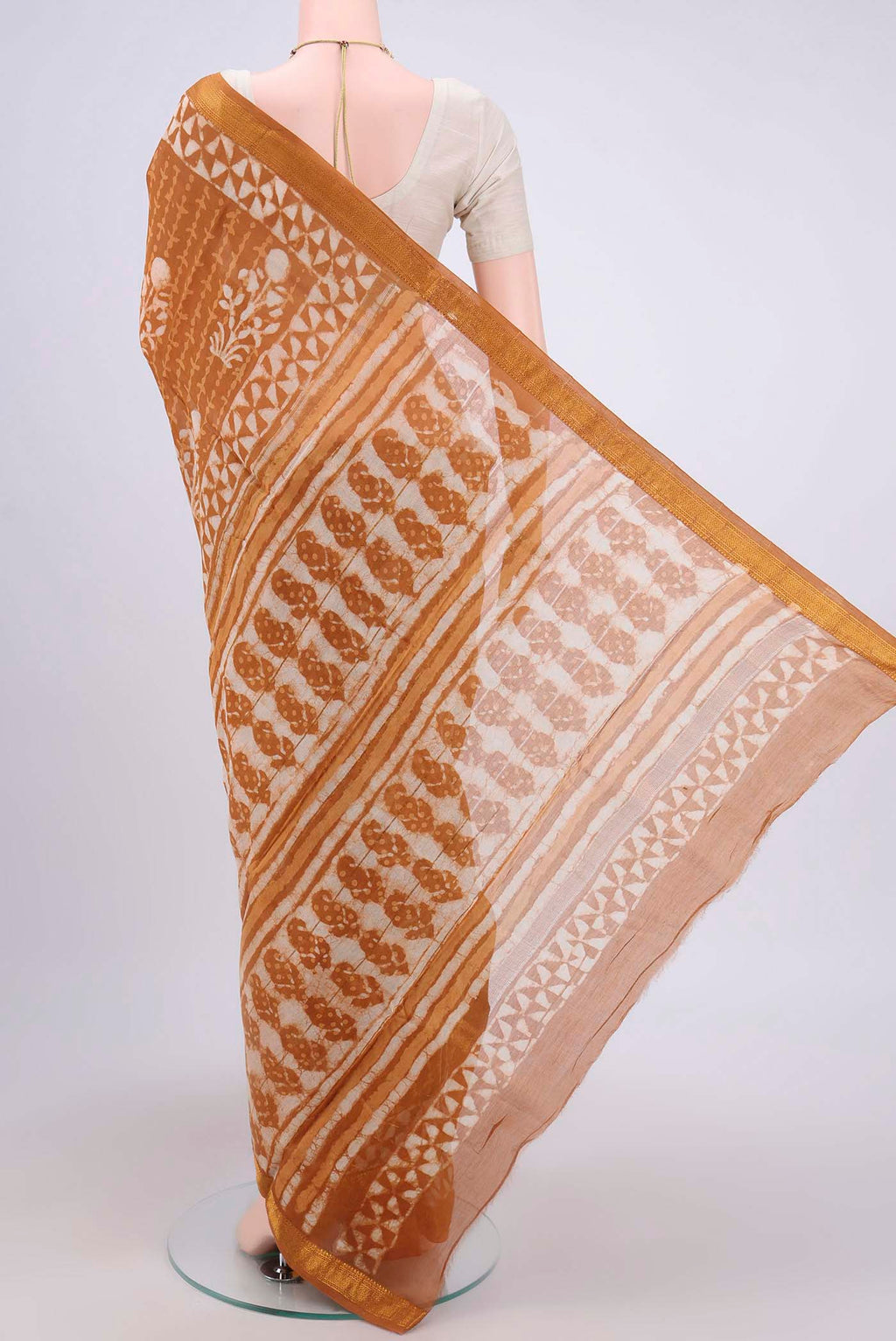 Flat view of Rust Maheshwari Silk Cotton Saree with Printed design on the body and Zari Border. 