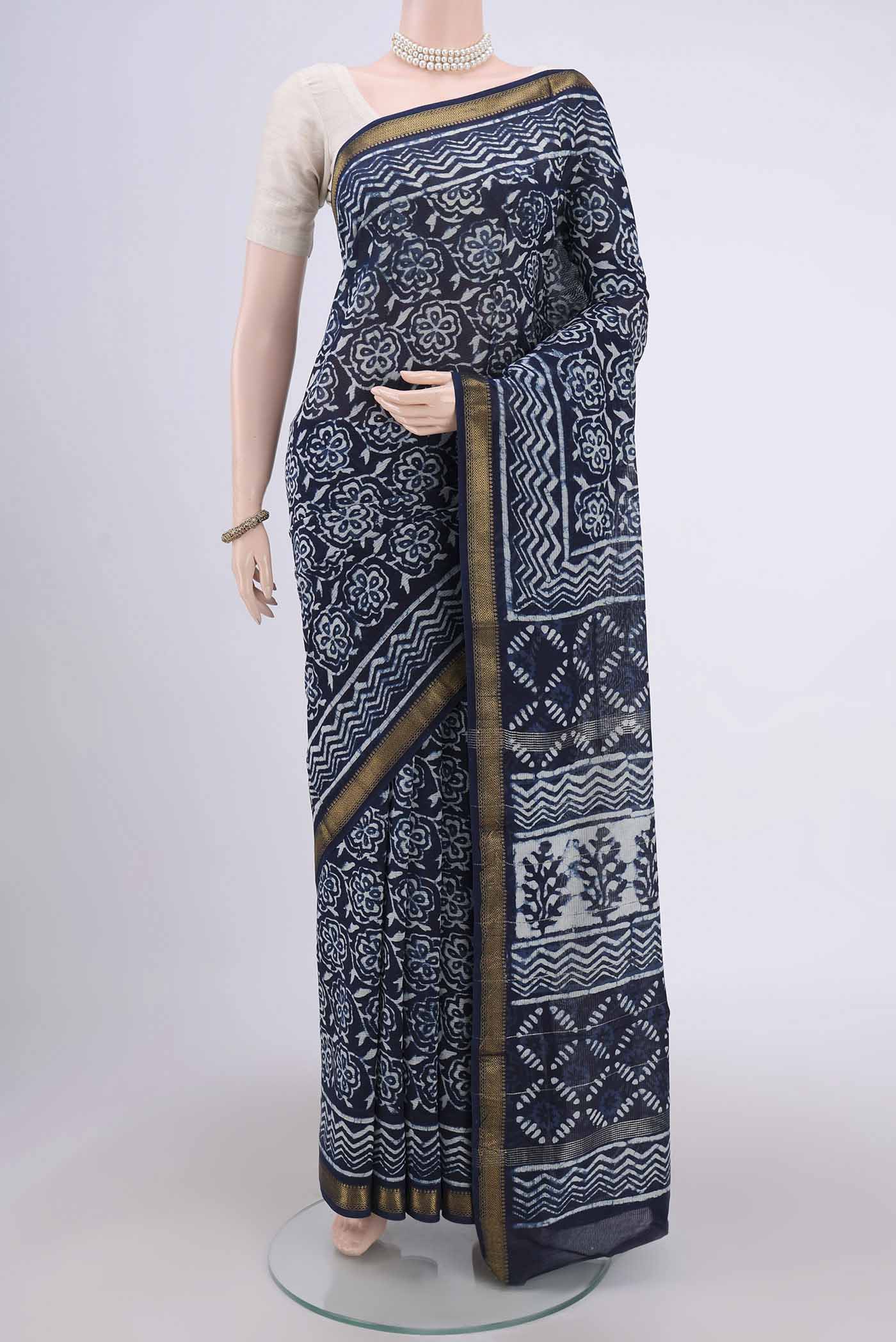 Indigo Maheshwari Silk Cotton Saree with Batik Print on the body and Zari Border.  displayed on a mannequin