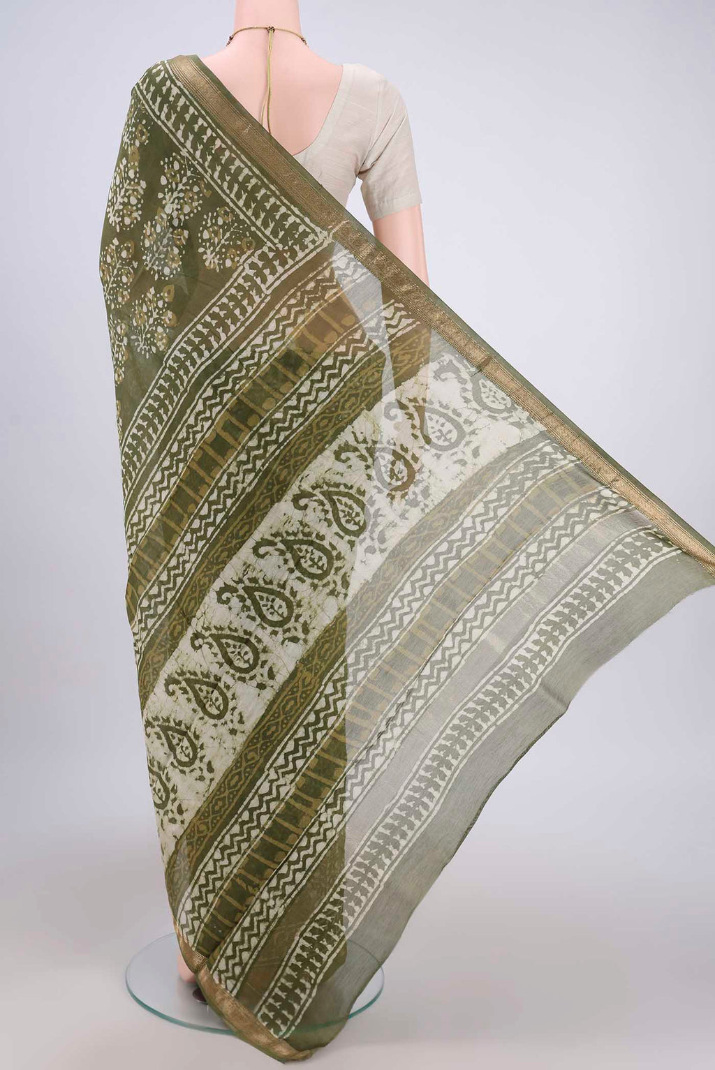 Flat view of Mehandi Green Maheshwari Silk Cotton Saree with Batik Print on the body and Zari Border. 