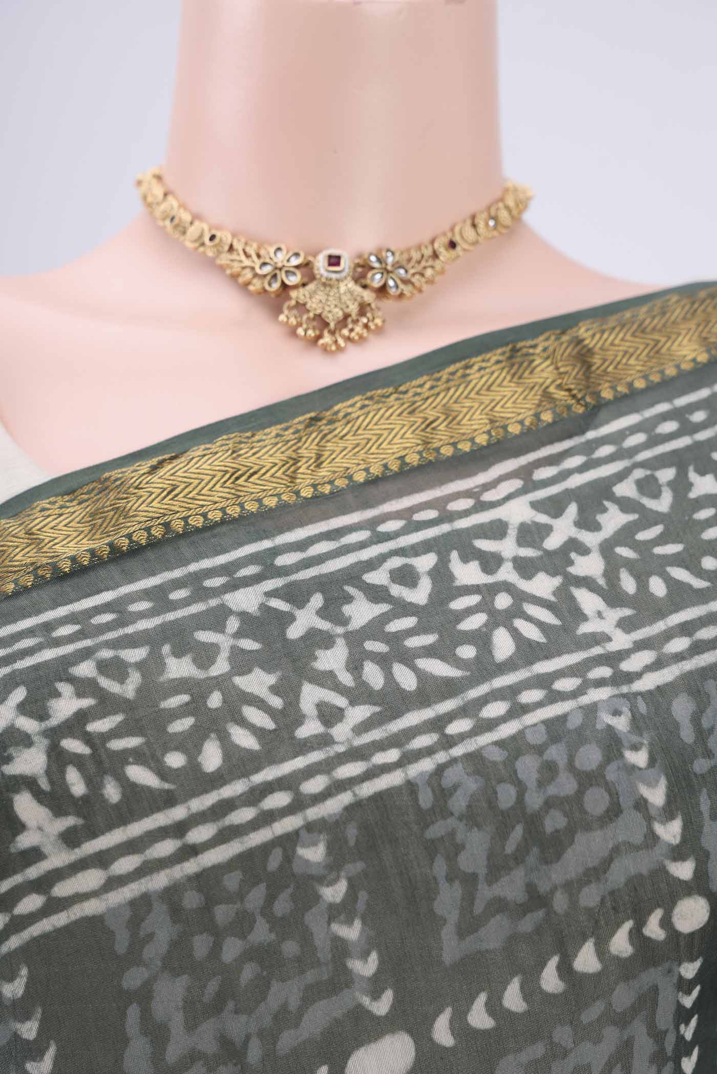 Border image of Olive Green Maheshwari Silk Cotton Saree with Batik Print on the body and Zari Border. 