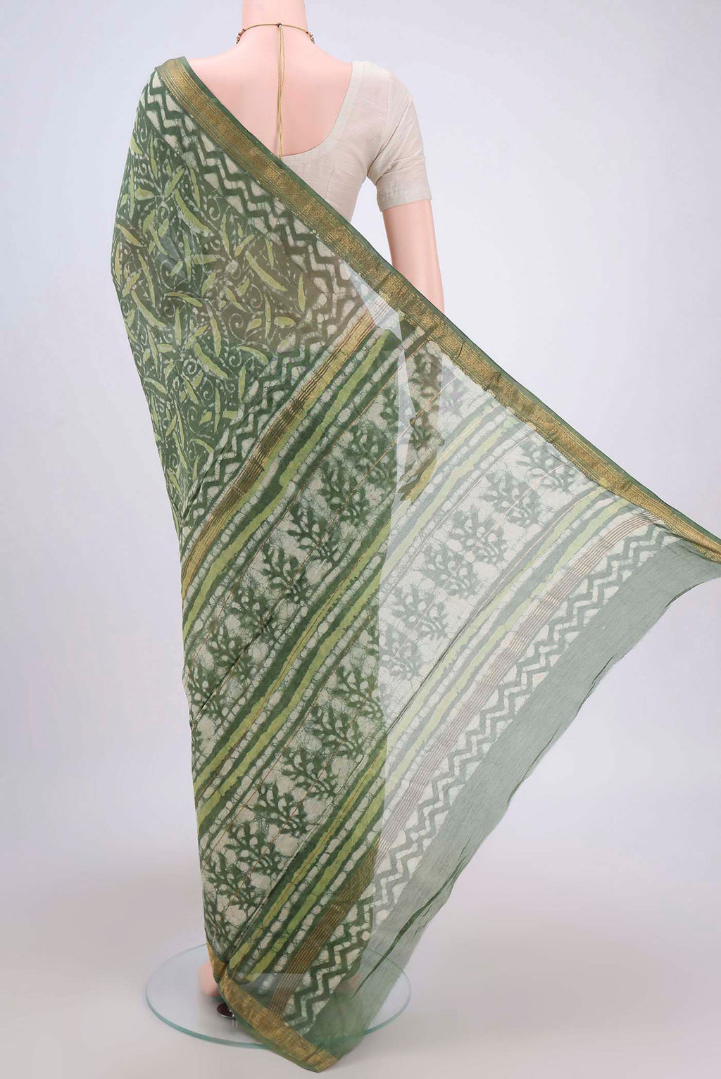 Flat view of Olive Green Maheshwari Silk Cotton Saree with Batik Print on the body and Zari Border. 