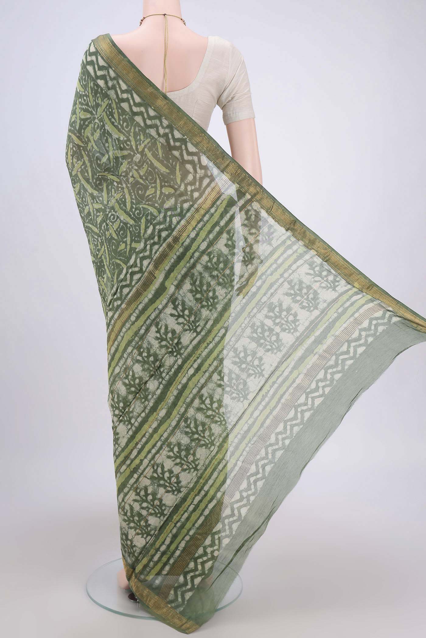 Flat view of Olive Green Maheshwari Silk Cotton Saree with Batik Print on the body and Zari Border. 
