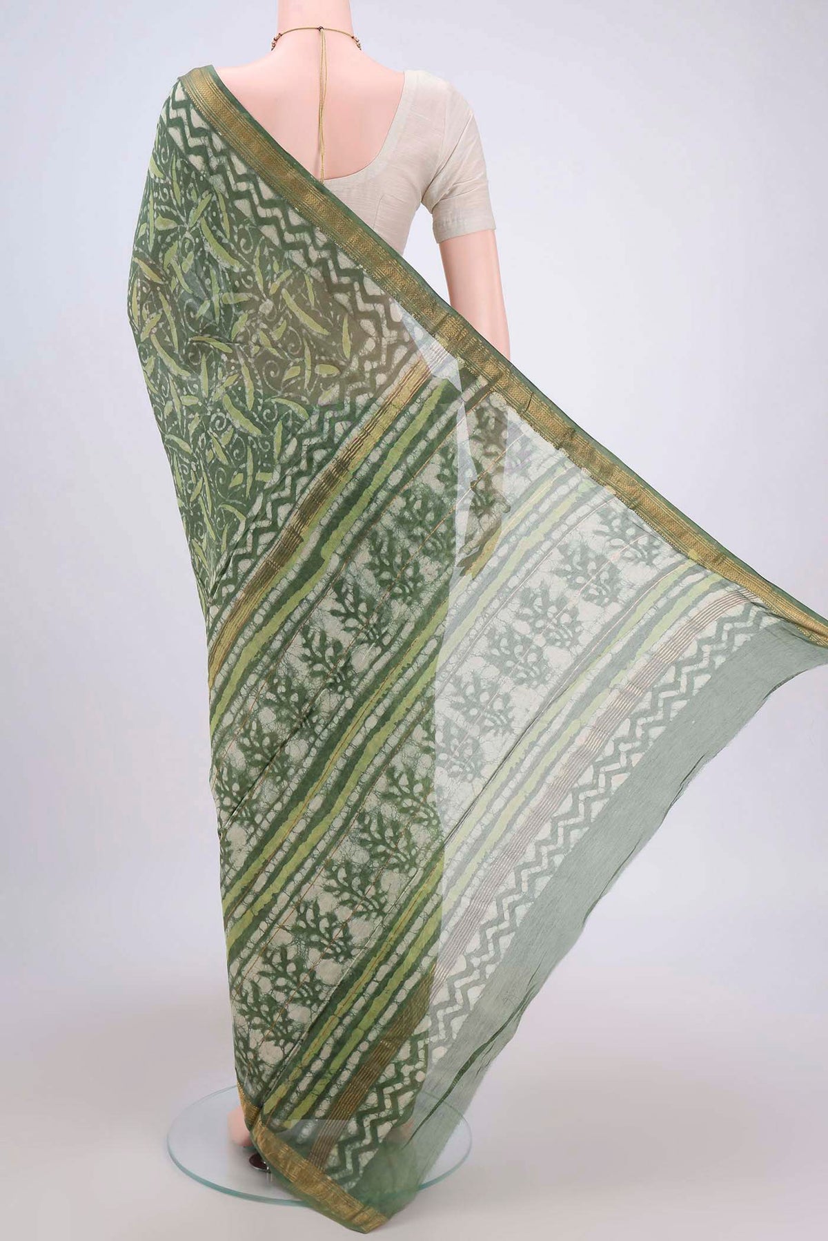 Flat view of Olive Green Maheshwari Silk Cotton Saree with Batik Print on the body and Zari Border. 